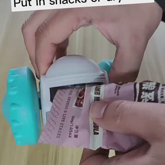 Video showing how to insert treats into the automatic treat dispenser robot toy.